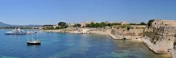Boats beside Corfu’s waterfront, with the Old Fortress on the right.