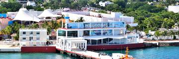 Punta Langosta International Cruise Terminal in Cozumel, Mexico, with cruise ships and the waterfront.