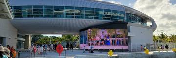 The Nassau Cruise Terminal in the Bahamas with modern buildings and cruise ships docked nearby.