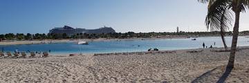 North Beach and lagoon at Ocean Cay MSC Marine Reserve with MSC Magnifica in the background.